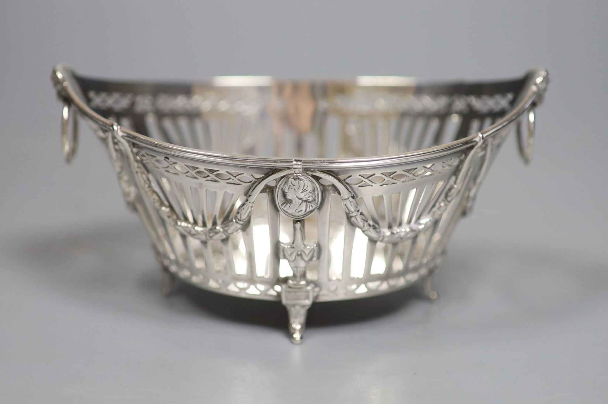 A late 19th/early 20th century Dutch pierced white metal ring handled navette shaped basket